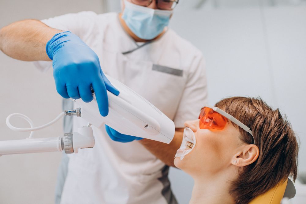a woman is getting dental treatment.