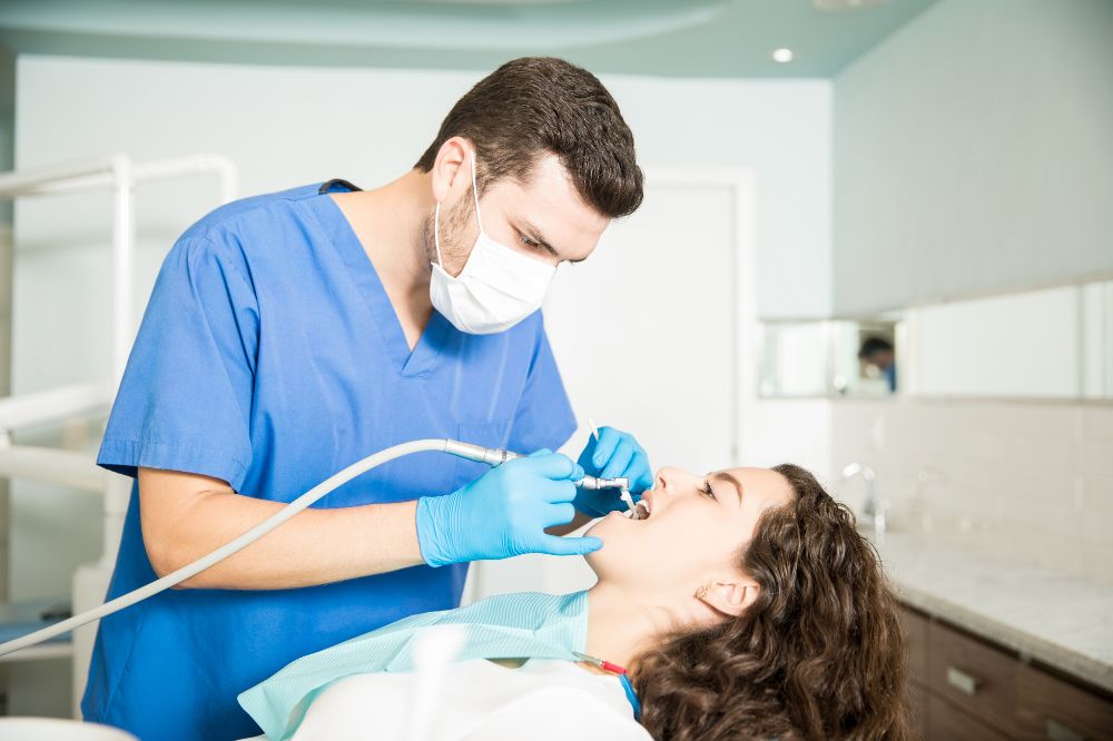 a woman is getting dental treatment.