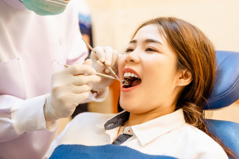 a woman is getting dental treatment.